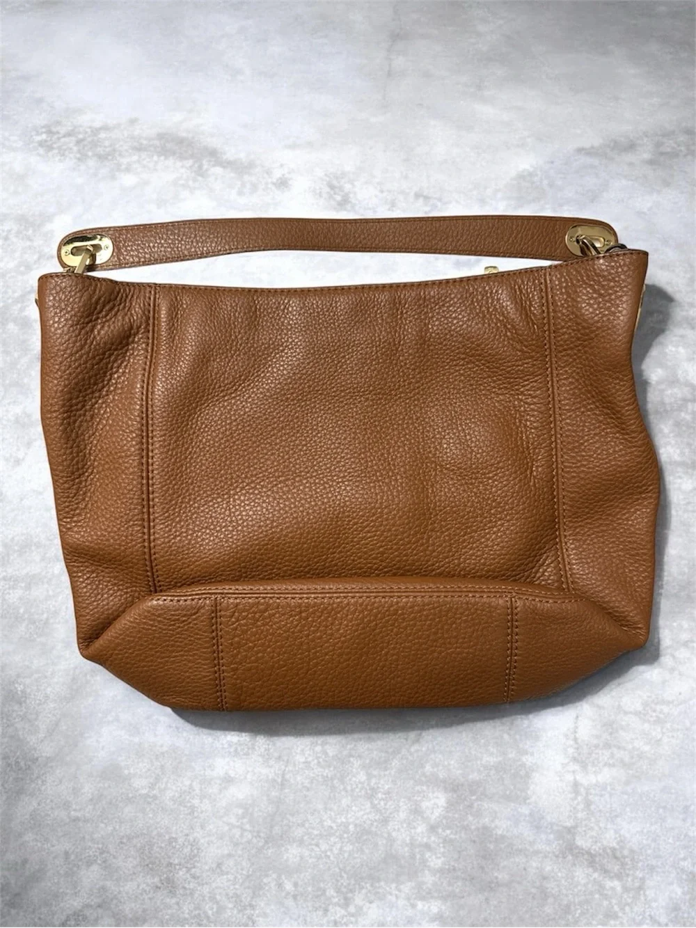 Michael Kors Cognac Pebbled Leather Shoulder Bag with Gold logo on the side.
